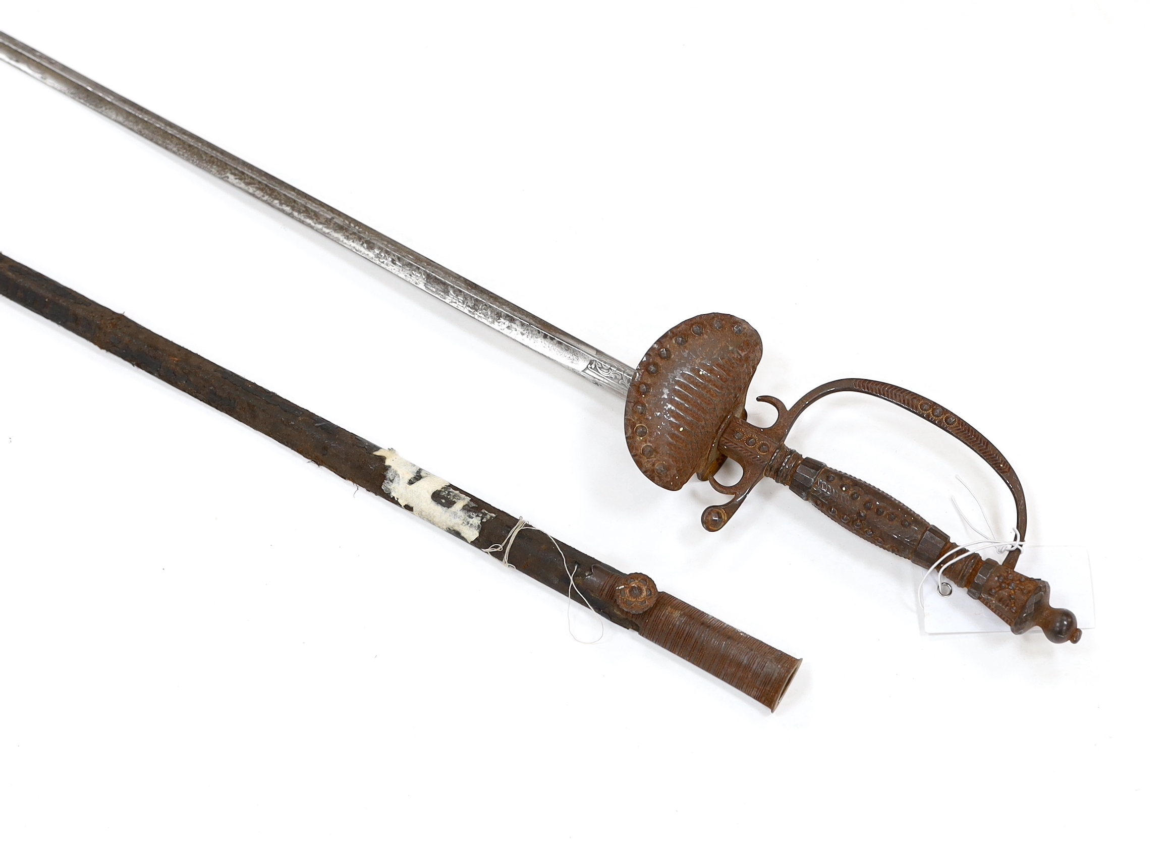 An English cut steel hilted dress court sword, c.1900, polished blade etched at forte, iron hilt slightly rusted, in its leather scabbard, blade 79cm